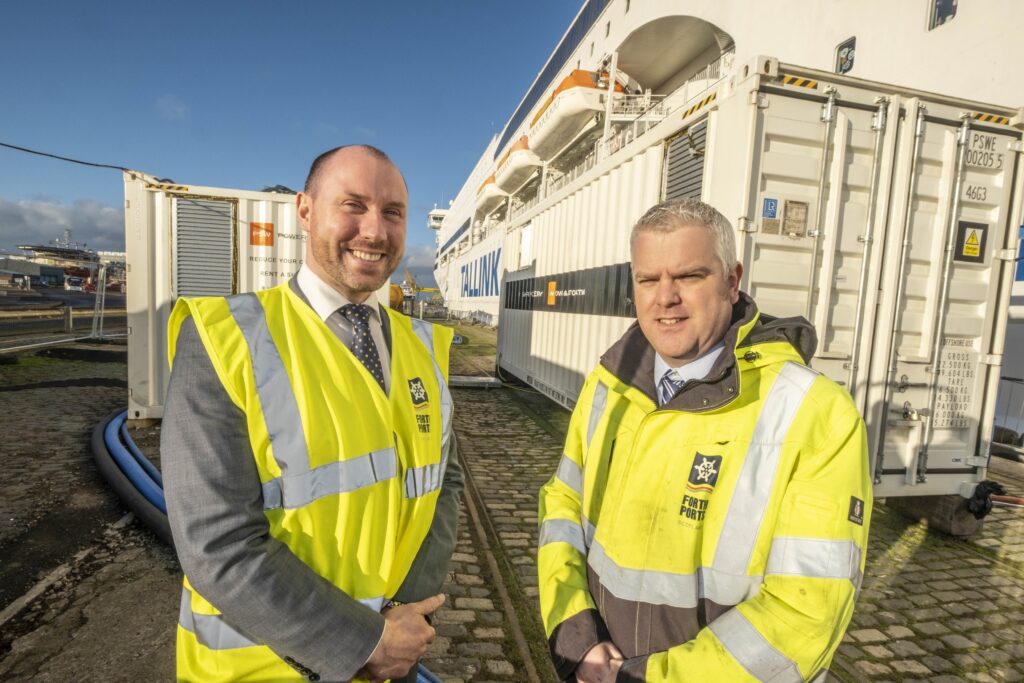 (L-R) Neil Gray, Minister with special responsibility for refugees from Ukraine with David Webster, Director of Energy at Forth Ports at the shore power system beside the Victoria 1 vessel which is currently berthed in the Port of Leith.