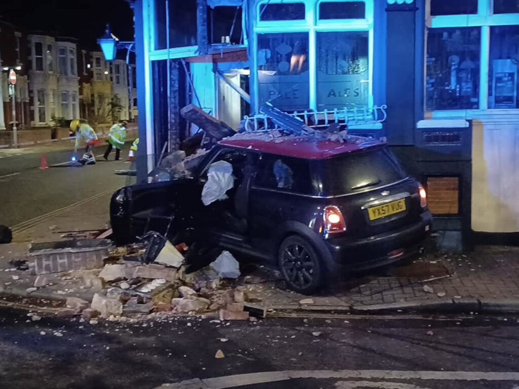 The Mini Cooper lodged into the Lawrence Arms