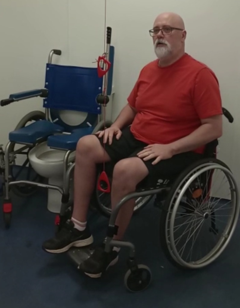 Gordon Alexander in a wheelchair, now paralysed after the crash.