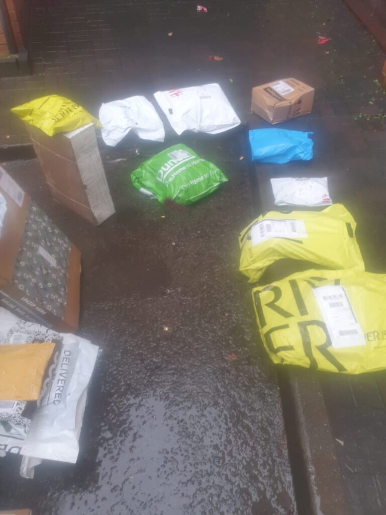 Clothing packages left on wet ground.