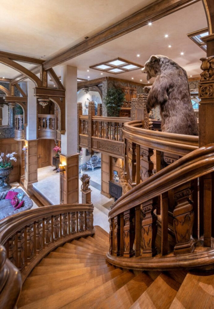 The spiralled staircase with the taxidermied bear.