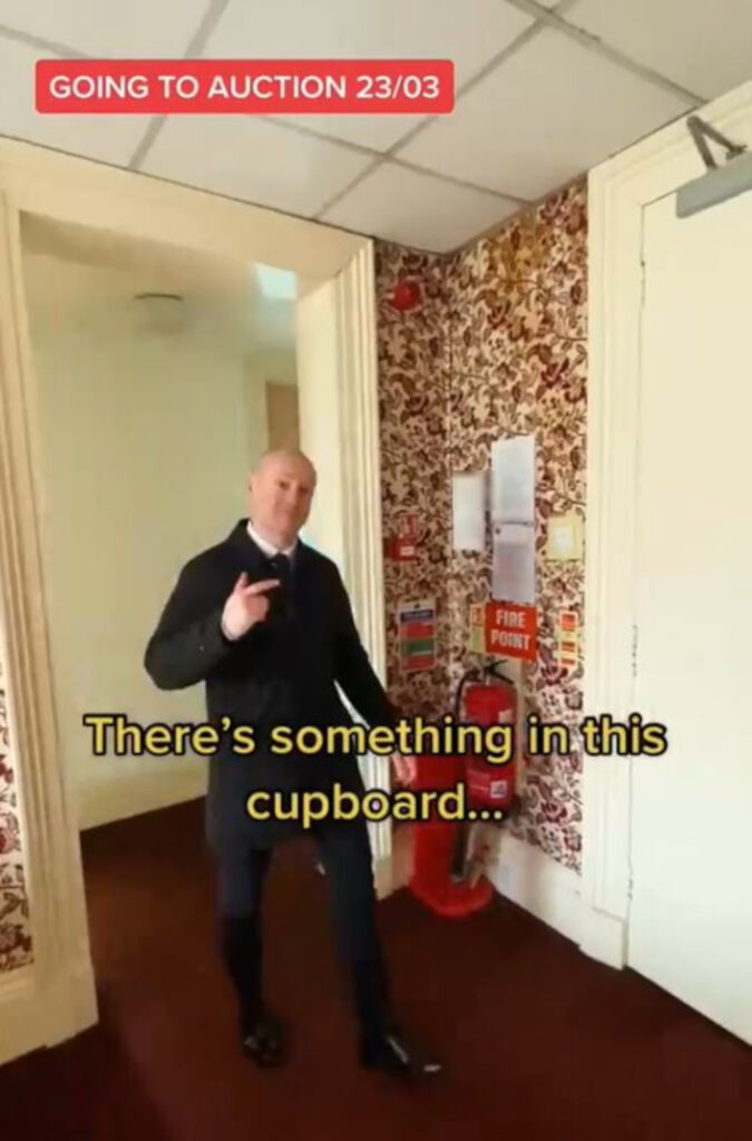 Man showing the cupboard.