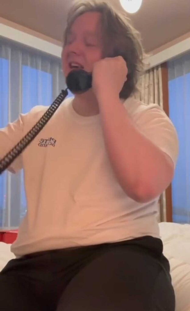 Lewis Capaldi pretending to be in a call.