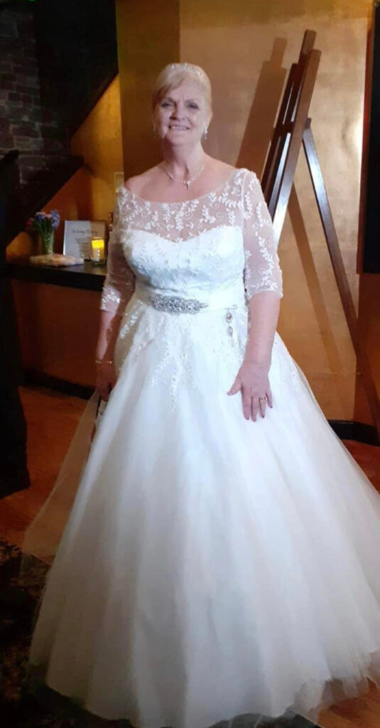 Dee dressed to the nines in her beautiful wedding dress.