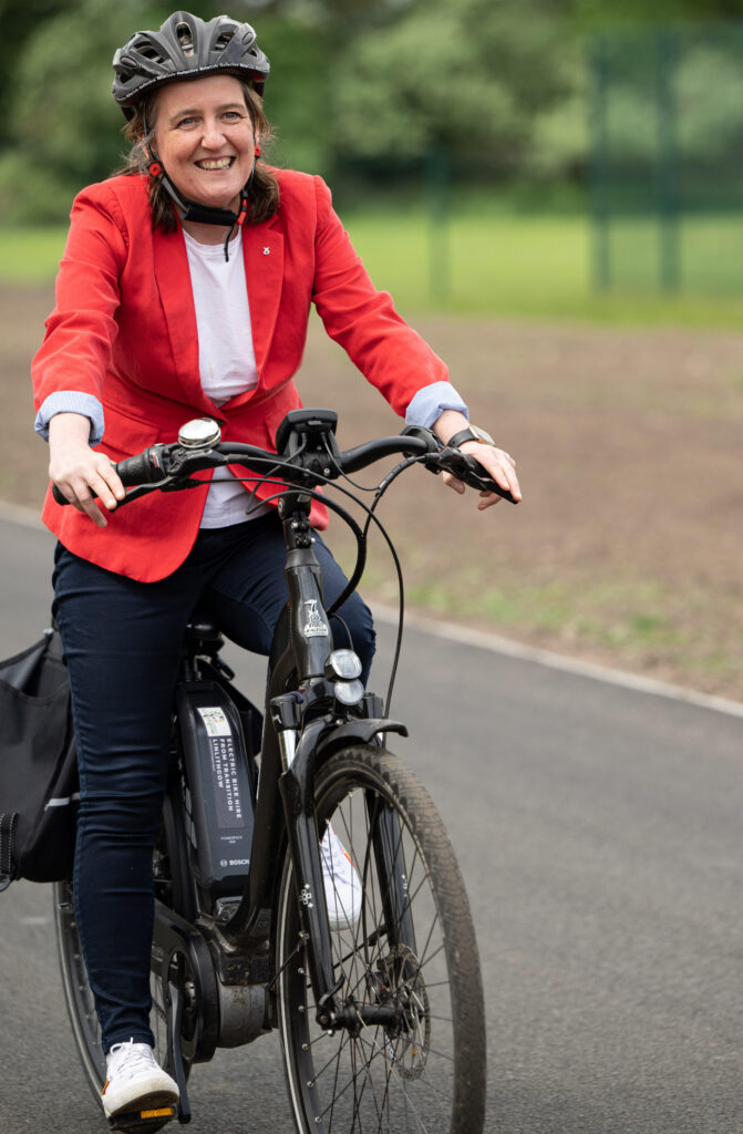 Sports Minister Maree Todd riding a bicycle.