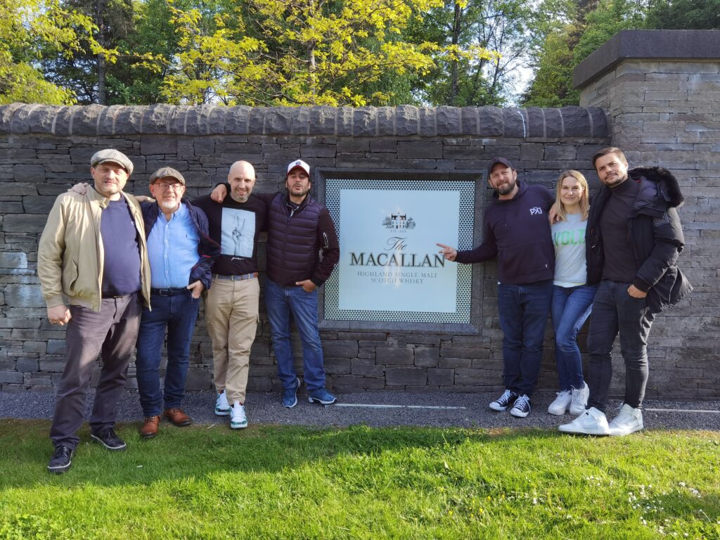 French chefs in front of the MacAllan distillery sign.