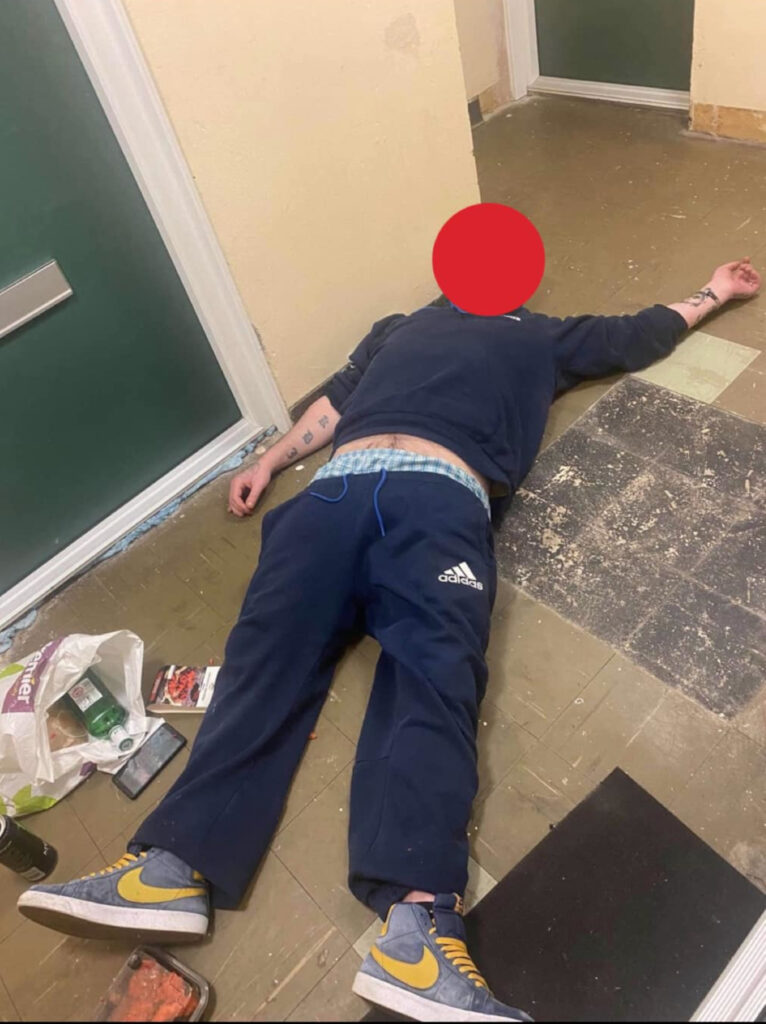 A man lying unconscious on the floor.