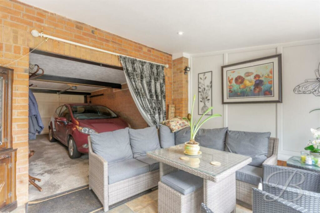 A three-bed cottage in England where the garage opens into a living area is on sale for £300k.