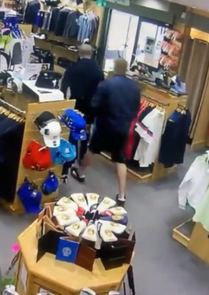 The two men exit the golf club shop