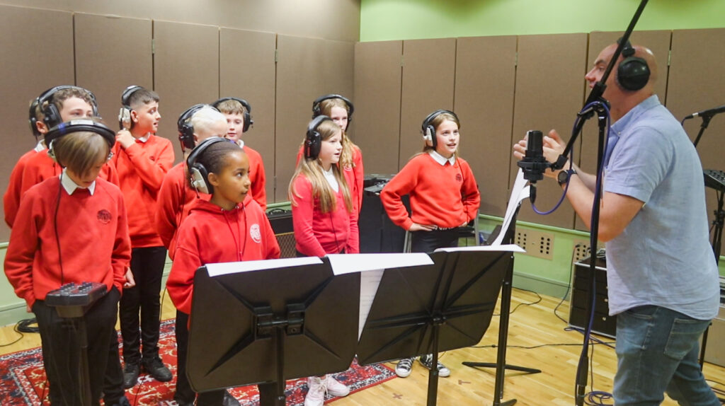 Pupils from Echline Primary School record their new song at Napier.