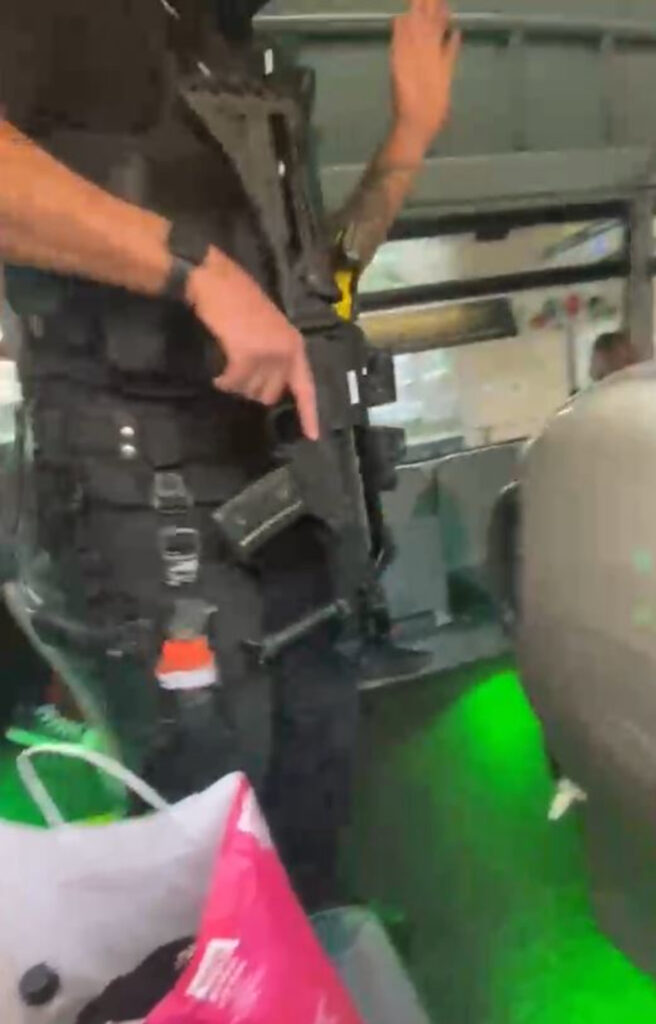 An officer wielding a gun.