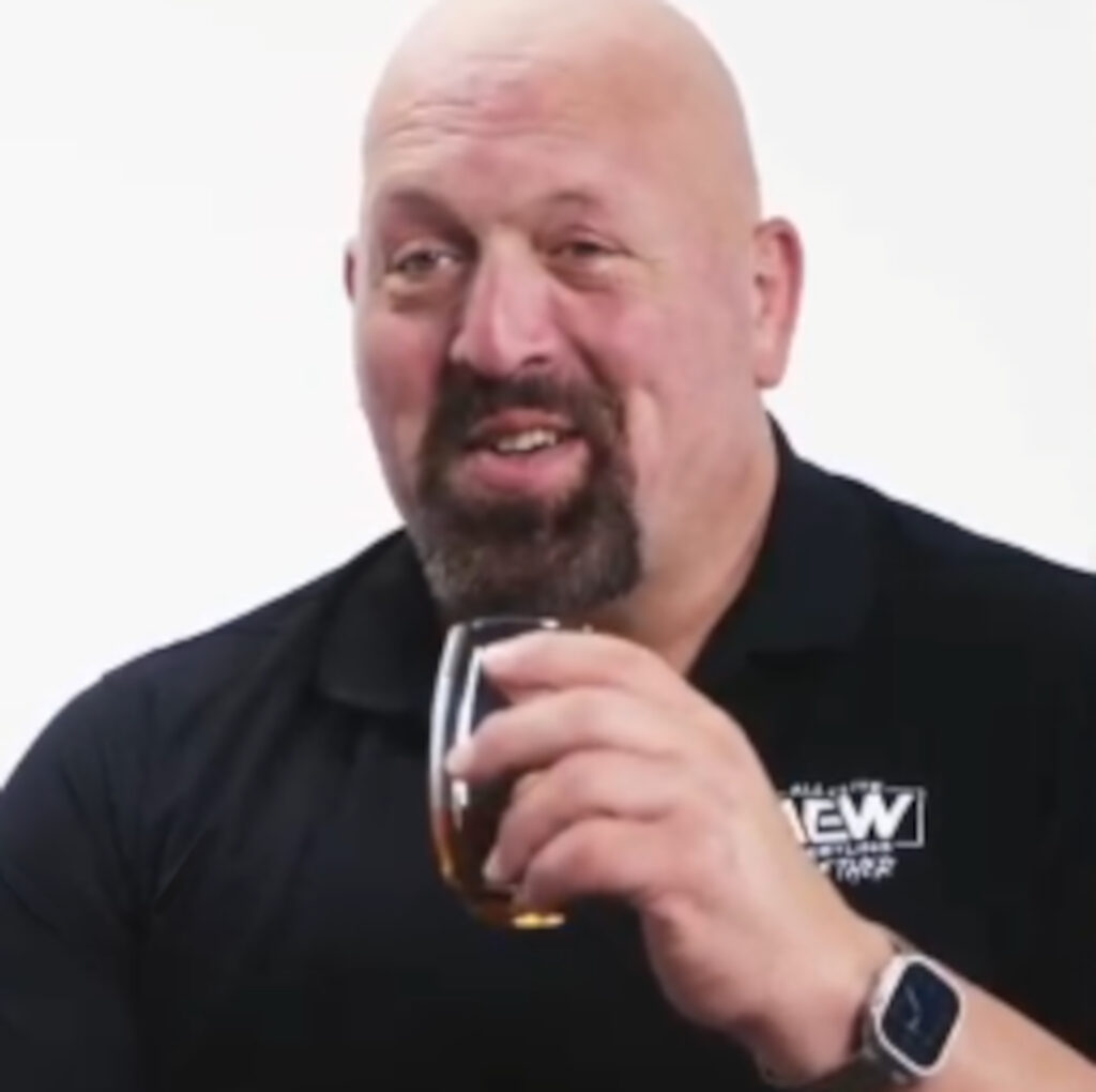 The Big Show holds a glass of Irn-Bru