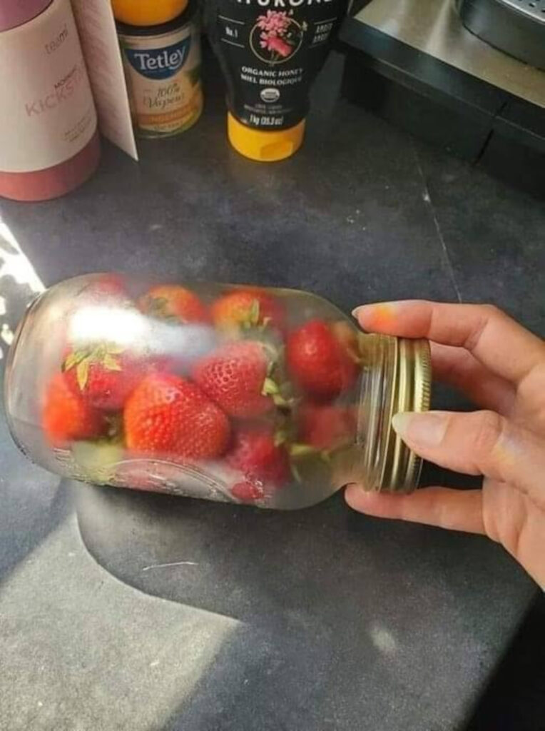 The strawberries in the jar.