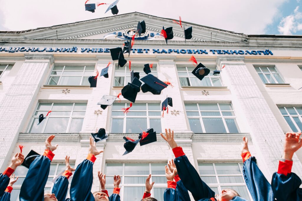 Students throwing their university caps in the air.