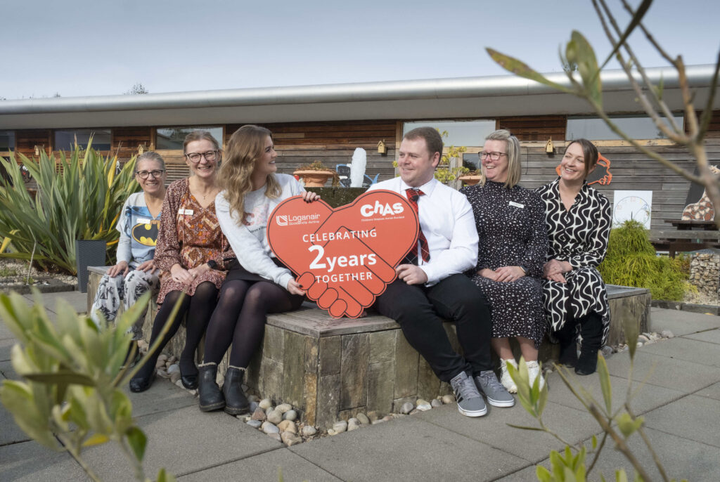 Staff from CHAS and Loganair celebrate their third year of continued partnership.