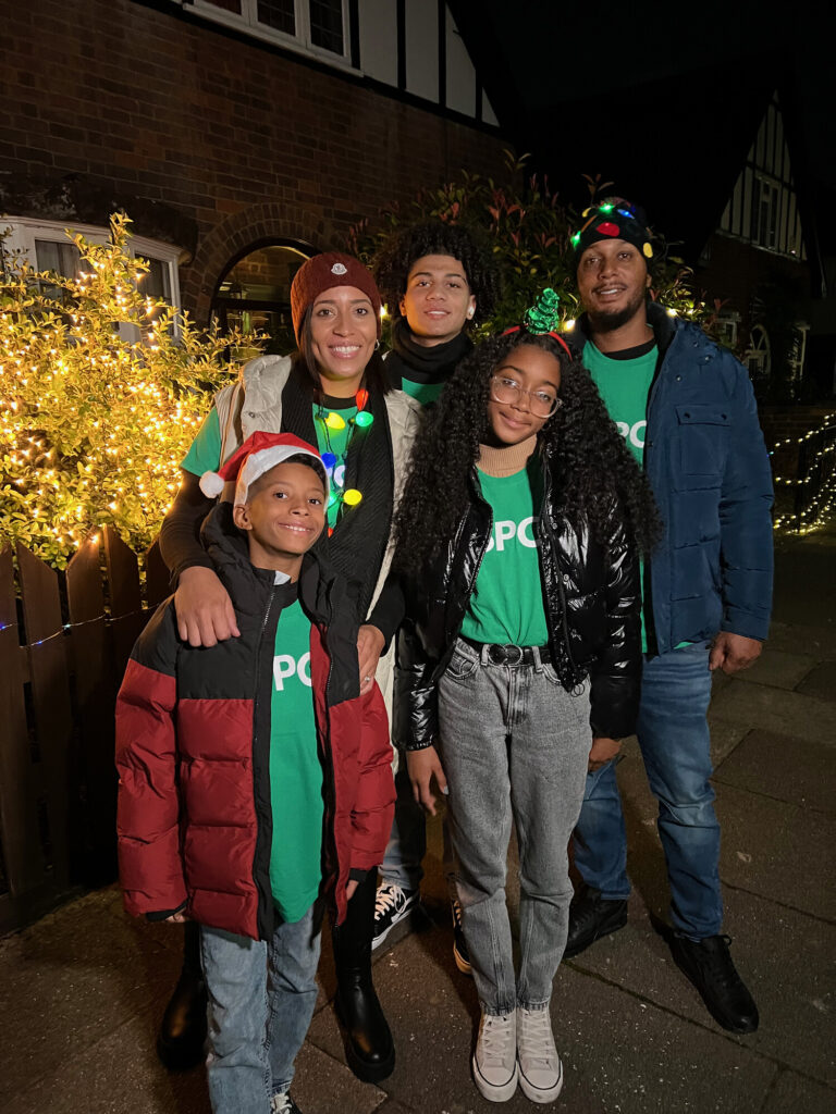A family wearing NSPCC t-shirts and festive accessories. Ready to go on their walk