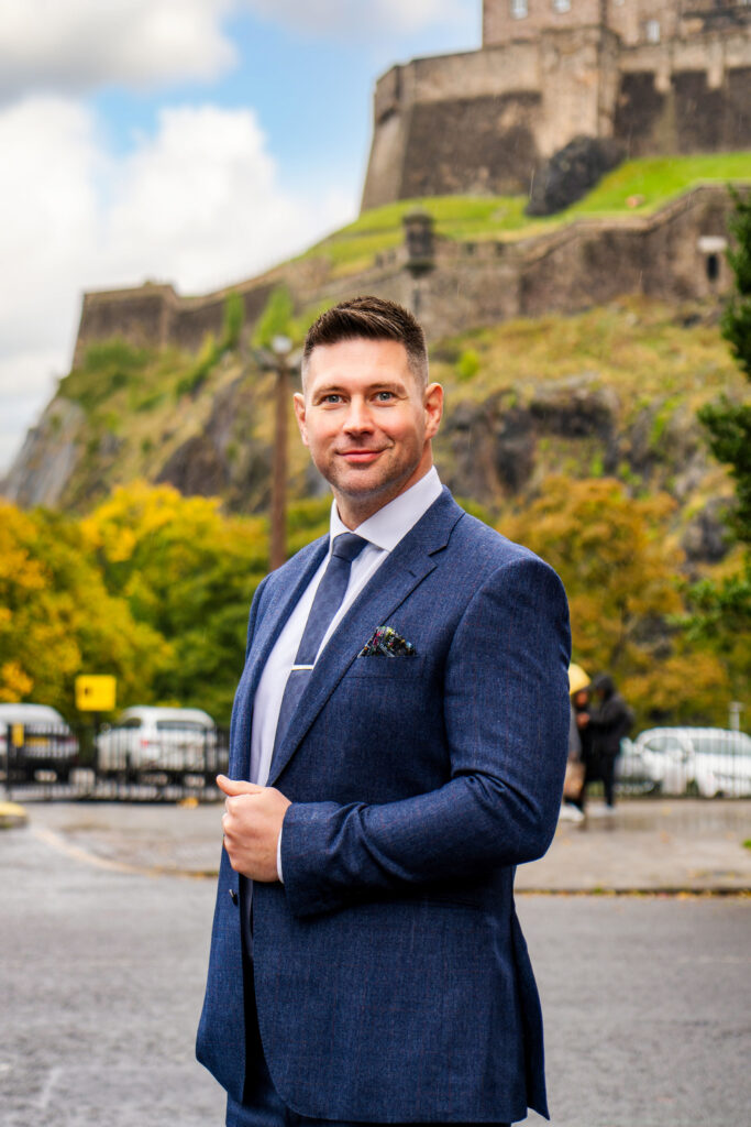 John Cox stood in front of Edinburgh Castle