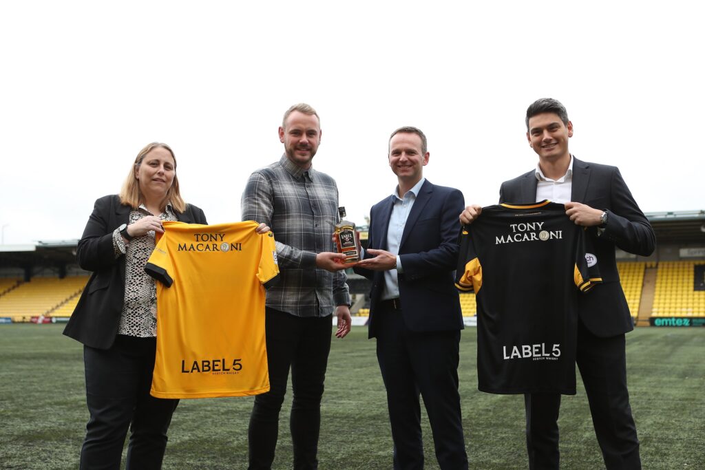 Representatives from Label 5 and Livingston FC display the new shirts.