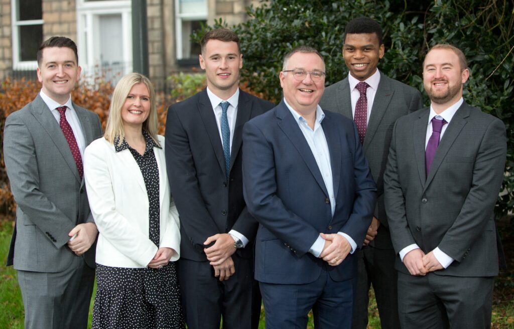 Managing partner Alistair Cummings, with the five new trainees.