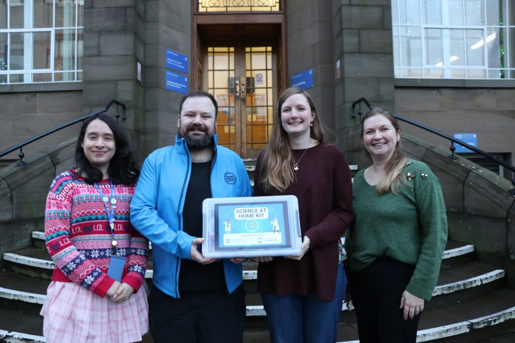 Clara Morriss, Jak Derrick-Ross, Victoria Marland, Heather Doran outside the LRCFS building holding one of the science kits