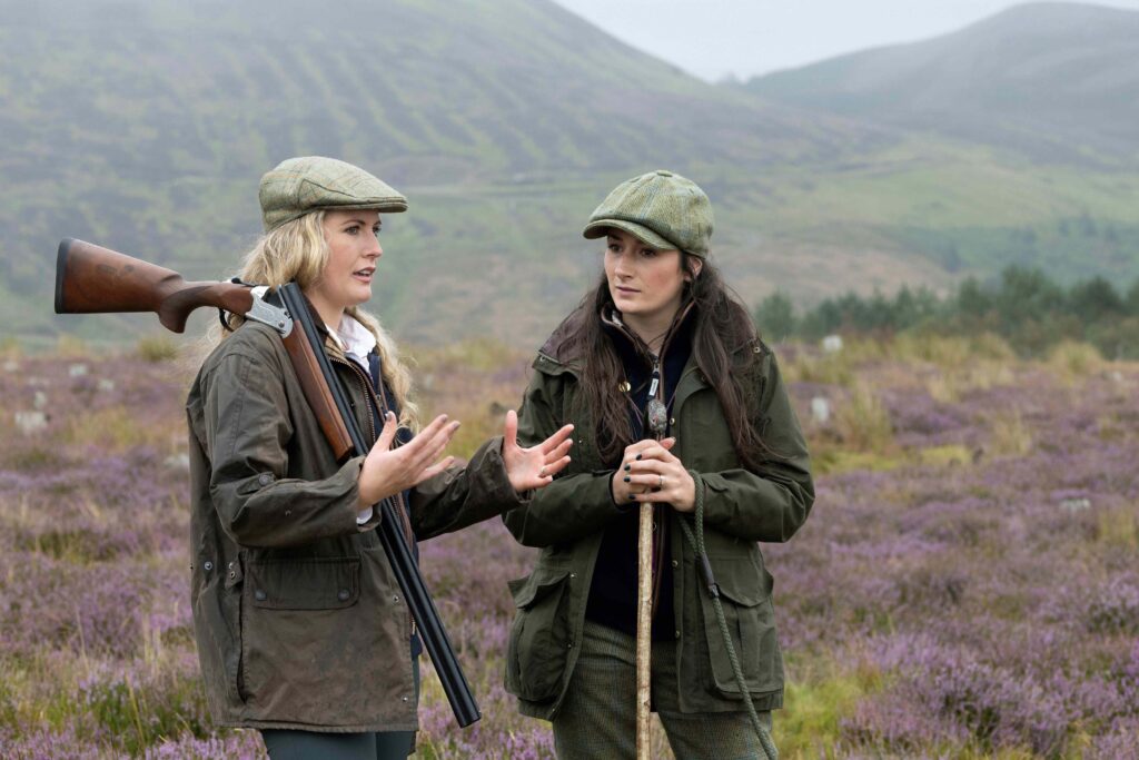 Two women in gear ready for grouse shooting