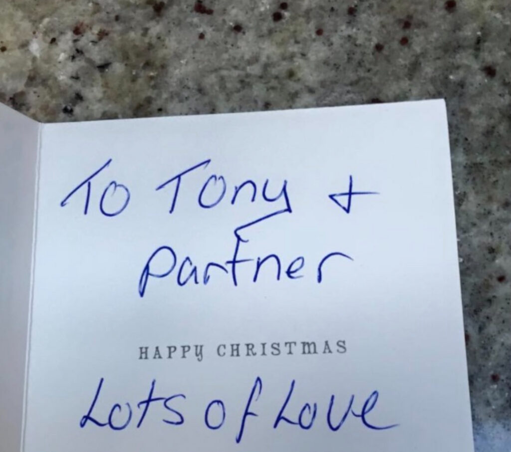 Image of the interior of the card reading 'To Tony and partner lots of love'