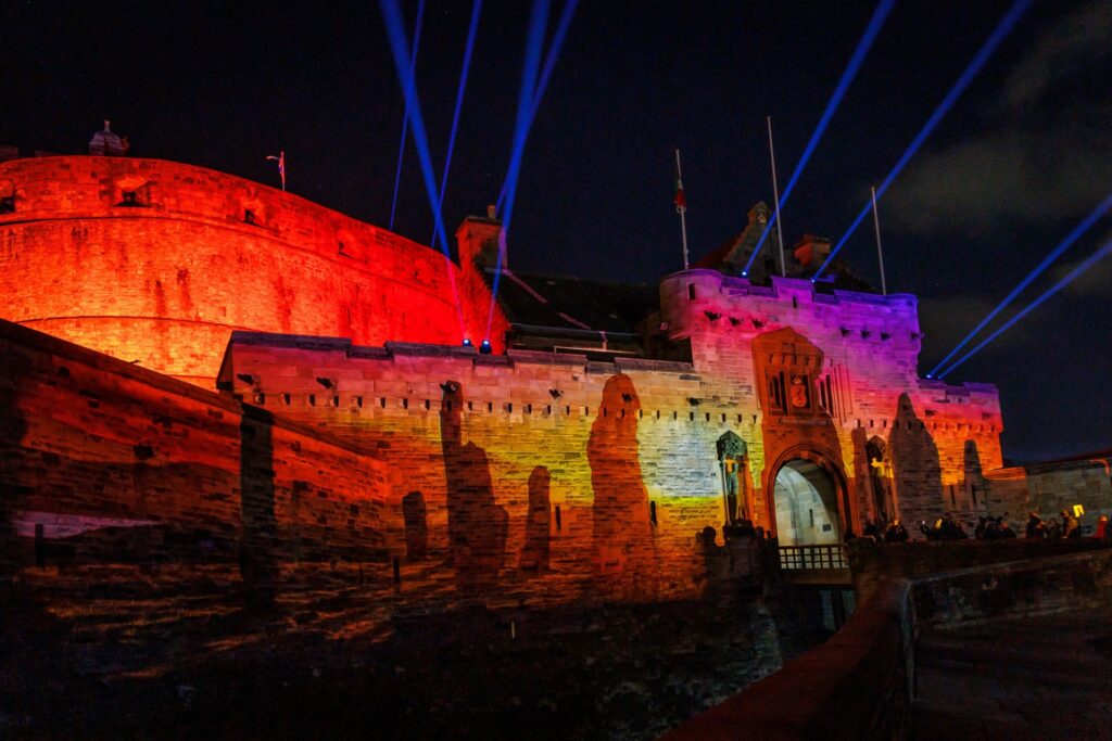 The castle lit up in orange colours.