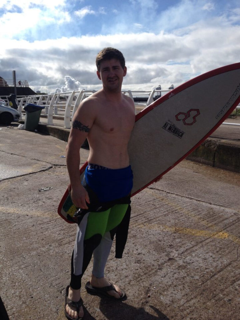 Dan Richards with a surfboard.