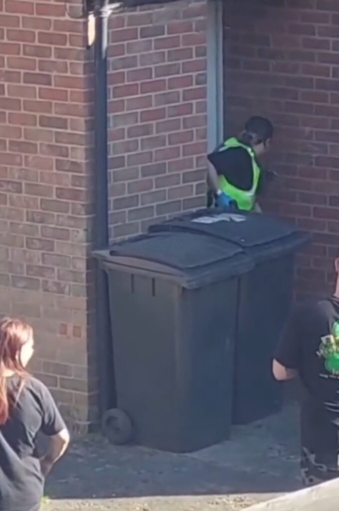 The officers were watched by a group that gathered.