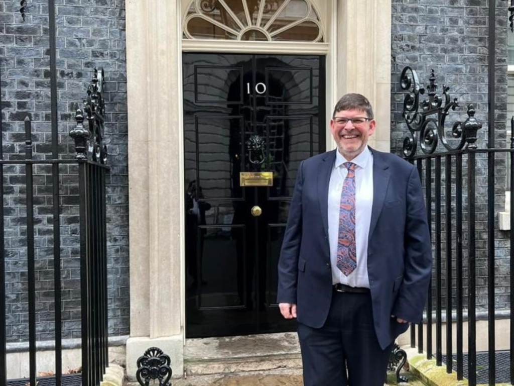 CEO Andrew Bissel standing in front of 10 Downing Street.
