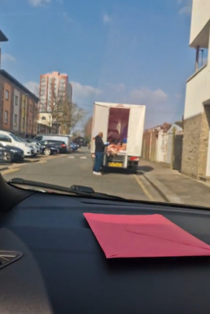 Disgusting moment bloke is spotted stepping all over pile of meat in back of delivery truck