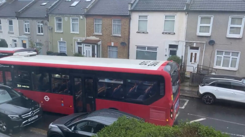 A bus was forced to reverse along the narrow road.