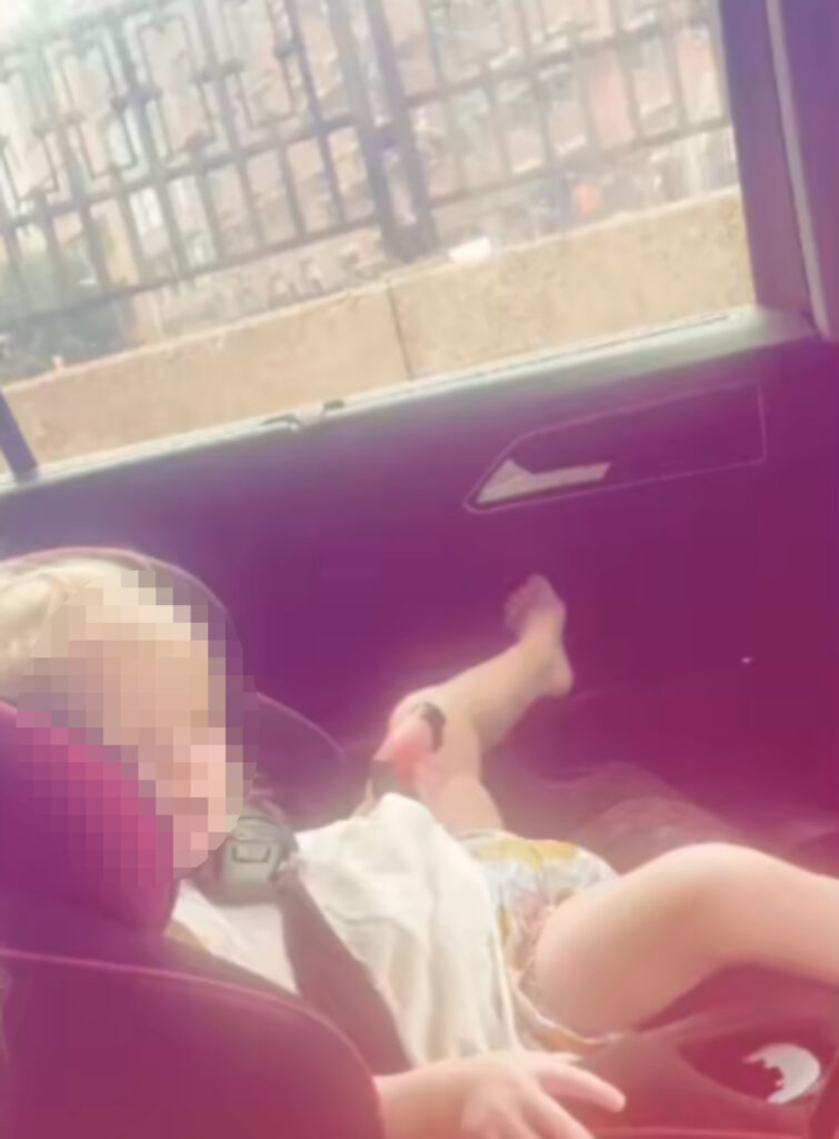 The baby was filmed puffing on the vape while her mother drove.