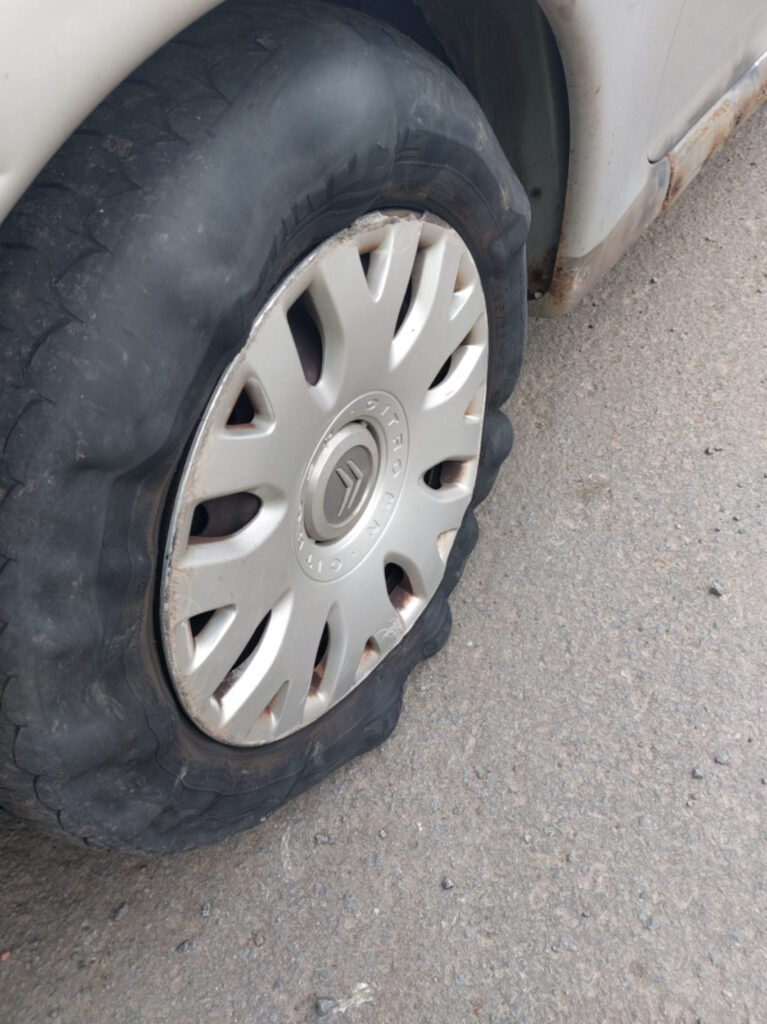 The tire was bulging in a number of places and had worn tread. 