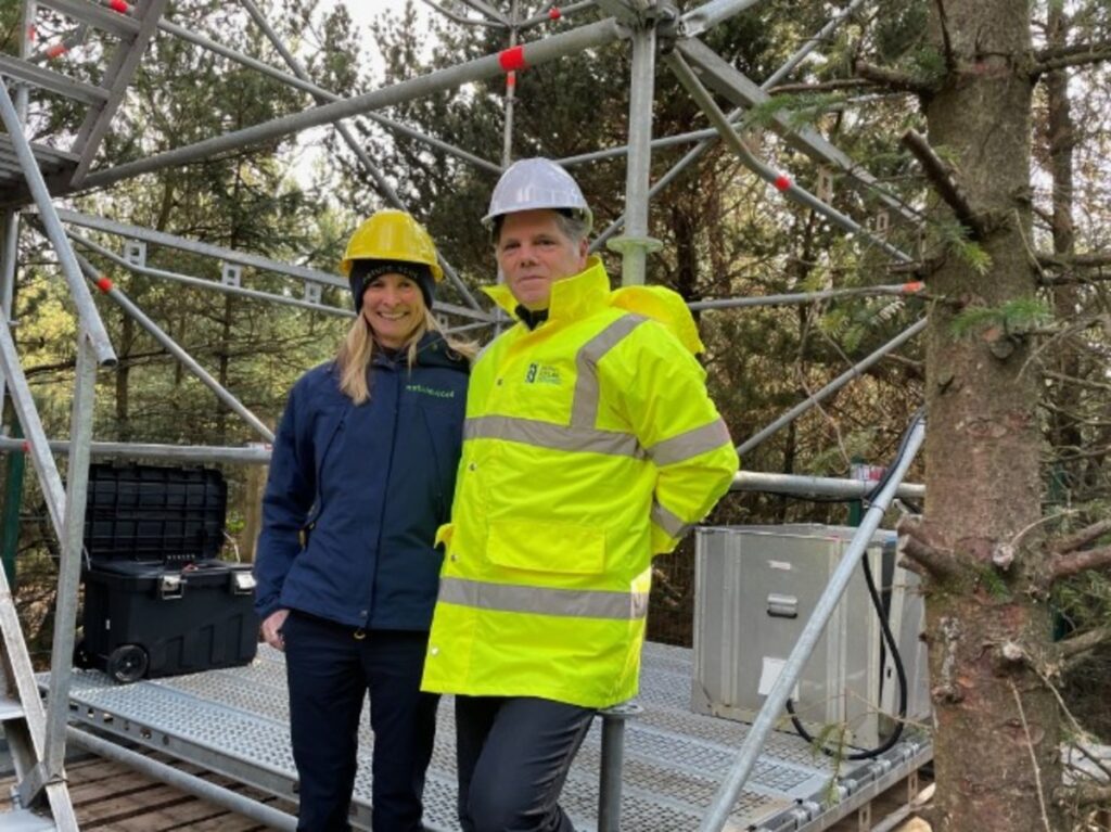 NatureScot Chief Executive Francesca Osowska and South of Scotland's Director of Net Zero, Nature & Entrepreneurship, Dr Martin Valenti, smile for a photo in hard hats at the Flux Tower.