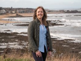 Charlotte Murray stood on the coast with North Berwick in the background (image supplied with release by Simpson and Marwick)