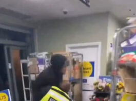 The shoplifter put the security guard in a headlock.