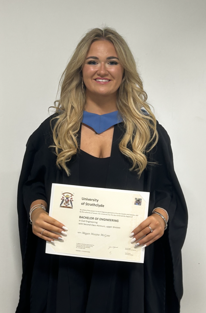 Megan standing with her degree. Image supplied with release by DBA