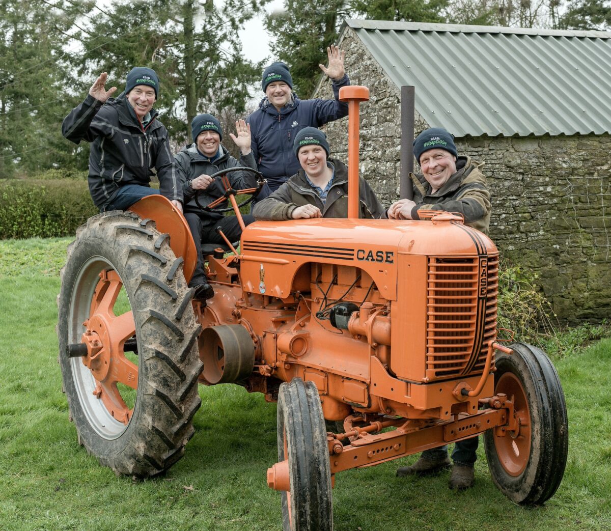 Three former Royal Marines with vintage tractor